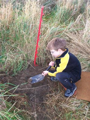 Here is  Carlin planting
his tree. 