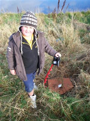 Here is  Kody planting
his tree. 