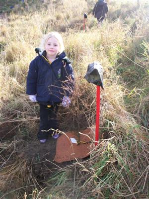 Here is Rhiannon planting
 her tree. 