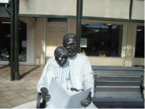 Statue of man reading. 