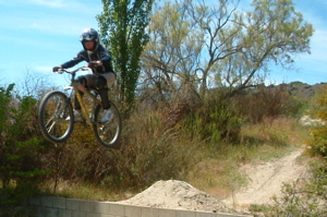 Hitting air on a track for downhill mountainbike riding near the Alexandra section of the rail trail.