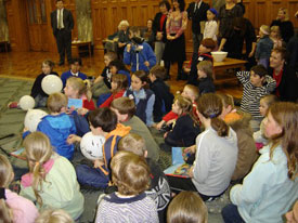 Students listening to story at book launch. 