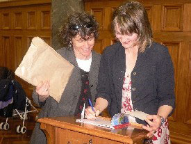 Ruth Paul signing a book. 