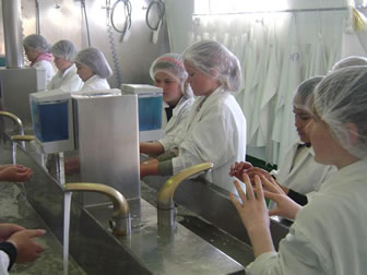 Image of students cleaning hands